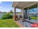 Covered patio with seating area, overlooking a grassy backyard at 1116 Hendon Loop, Davenport, FL 33837