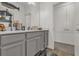 Clean bathroom with gray vanity and built-in shelves at 1116 Hendon Loop, Davenport, FL 33837