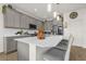 Modern kitchen with gray cabinets, quartz countertops, and stainless steel appliances at 1116 Hendon Loop, Davenport, FL 33837