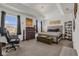 Main bedroom with tufted headboard, large windows and a workspace at 1116 Hendon Loop, Davenport, FL 33837