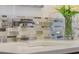 Close-up of the stylish bathroom sink area showcasing modern fixtures, a quartz counter, and a mosaic backsplash at 17577 Davenport Rd, Winter Garden, FL 34787