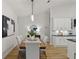 Dining room with a wood table, white chairs and hardwood floors at 17577 Davenport Rd, Winter Garden, FL 34787