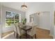 Bright dining room with a dark wood table and elegant upholstered chairs, plus a view of the landscaped yard at 17577 Davenport Rd, Winter Garden, FL 34787