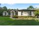 White house with a gray roof, landscaping, and walkway at 17577 Davenport Rd, Winter Garden, FL 34787