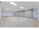 Bright and spacious garage interior with two large roll-up doors at 17577 Davenport Rd, Winter Garden, FL 34787