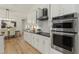 Kitchen with white cabinets, granite countertops and stainless steel appliances at 17577 Davenport Rd, Winter Garden, FL 34787