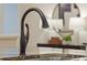 Modern kitchen sink and faucet with granite countertop at 17577 Davenport Rd, Winter Garden, FL 34787