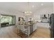 Kitchen with white cabinets, granite countertops and stainless steel appliances at 17577 Davenport Rd, Winter Garden, FL 34787