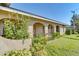 Charming, beige stucco home featuring arched entryways, lush landscaping, and a well-manicured lawn at 206 Diamond Cv # 108, Casselberry, FL 32707