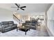 Spacious living room featuring a ceiling fan, modern furniture, and an open view of the kitchen at 4271 Tigris Dr, Apopka, FL 32712