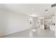 Open floor plan with neutral tile, white walls, and island, creating a spacious living area at 1249 Atlantic Ave, Fruitland Park, FL 34731