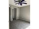 Bedroom with gray walls, ceiling fan, and closet space at 2649 Crown Ct # 2649, Kissimmee, FL 34741