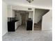 Open concept kitchen with staircase and matching black and white decor at 2649 Crown Ct # 2649, Kissimmee, FL 34741