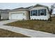 One-story home with a white exterior, two-car garage, and landscaping at 334 Rover Rd, Ormond Beach, FL 32174
