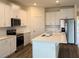 Modern kitchen with white cabinets, stainless steel appliances, and an island at 334 Rover Rd, Ormond Beach, FL 32174