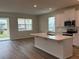 Open concept kitchen and living area with hardwood floors and an island at 334 Rover Rd, Ormond Beach, FL 32174