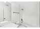 Well-lit bathroom includes a shower-tub with stylish fixtures and tiled walls at 634 Burch Ave, Winter Garden, FL 34787