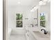 Bright bathroom featuring double vanity, sleek black faucets, and a garden view at 634 Burch Ave, Winter Garden, FL 34787