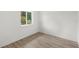 Minimalist bedroom featuring modern wood floors and natural light at 634 Burch Ave, Winter Garden, FL 34787