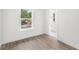 Bedroom with modern flooring and natural light leading to a half bath at 634 Burch Ave, Winter Garden, FL 34787