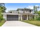 Two-story home featuring stone accents, a two-car garage, and a well-manicured lawn at 634 Burch Ave, Winter Garden, FL 34787