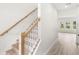 Interior view of staircase with wood railings and a hallway leading to sunlit room at 634 Burch Ave, Winter Garden, FL 34787