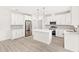 Contemporary kitchen with white cabinets, stainless steel appliances, a center island, and stylish pendant lighting at 634 Burch Ave, Winter Garden, FL 34787