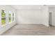 Bright living room featuring sleek flooring, recessed lighting, large windows, and ample space for furniture at 634 Burch Ave, Winter Garden, FL 34787