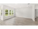 Open-concept living space with sleek flooring and large windows allowing natural light to illuminate the space at 634 Burch Ave, Winter Garden, FL 34787