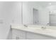 Bright bathroom featuring a double sink vanity, sleek white cabinets, and a large mirror at 345 River Front Way, Edgewater, FL 32141