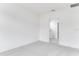 Clean, empty bedroom with neutral carpeting, white walls, and a door to the ensuite bathroom at 345 River Front Way, Edgewater, FL 32141