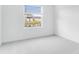 Carpeted bedroom featuring a window overlooking a calm pond and neighboring houses at 345 River Front Way, Edgewater, FL 32141