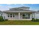 Covered patio offers a seamless transition to outdoor enjoyment, with a view of the green lawn and landscaped backyard at 5249 Stone Ridge Pl, St Cloud, FL 34771