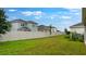 Expansive backyard with a privacy fence encloses a lush green lawn, offering space for recreation and relaxation at 5249 Stone Ridge Pl, St Cloud, FL 34771