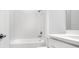 A well-lit bathroom includes a shower-tub combination with white tiling, complemented by a sleek sink and vanity at 5249 Stone Ridge Pl, St Cloud, FL 34771