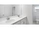 Bright bathroom features double sinks, white cabinets, and a large mirror, providing a modern and clean aesthetic at 5249 Stone Ridge Pl, St Cloud, FL 34771