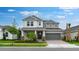 Charming two-story home featuring a gray color scheme, manicured lawn, and attached two-car garage at 5249 Stone Ridge Pl, St Cloud, FL 34771