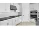 Modern kitchen with white cabinets, stainless steel range hood, and stylish backsplash at 5249 Stone Ridge Pl, St Cloud, FL 34771