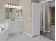 A sleek bathroom features modern vanity with marble countertop and tile flooring at 11045 Belmere Isles Ct, Windermere, FL 34786