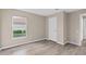 Neutral bedroom features hardwood flooring and natural light from the window at 11045 Belmere Isles Ct, Windermere, FL 34786