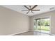 Bright bedroom featuring a ceiling fan, wood flooring, and sliding glass doors to the outside at 11045 Belmere Isles Ct, Windermere, FL 34786