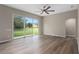 Bedroom features light wood-look floors and sliding doors that lead to the backyard at 11045 Belmere Isles Ct, Windermere, FL 34786