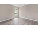 Neutral bedroom with hardwood flooring and a window for natural light at 11045 Belmere Isles Ct, Windermere, FL 34786