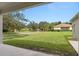 A lovely front lawn with green grass and shade trees, framed by the home's structure at 11045 Belmere Isles Ct, Windermere, FL 34786