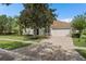 Charming single-story home with a tile roof, brick driveway, and a beautifully landscaped front yard at 11045 Belmere Isles Ct, Windermere, FL 34786