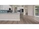 Modern kitchen with stainless steel appliances, white cabinets, and blue backsplash at 11045 Belmere Isles Ct, Windermere, FL 34786