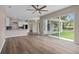 Open-concept living space with light wood-look flooring, modern kitchen, and access to an outdoor patio at 11045 Belmere Isles Ct, Windermere, FL 34786