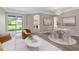 Cozy living room area with modern furnishings, neutral tones, and a view of the backyard at 11045 Belmere Isles Ct, Windermere, FL 34786