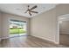 Living room with ceiling fan and sliding glass doors that open up to the outdoor space at 11045 Belmere Isles Ct, Windermere, FL 34786