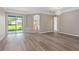 Neutral toned living room with wood floors and sliding glass doors to the backyard at 11045 Belmere Isles Ct, Windermere, FL 34786